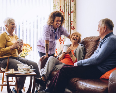 a caregiver talking to a group of seniors
