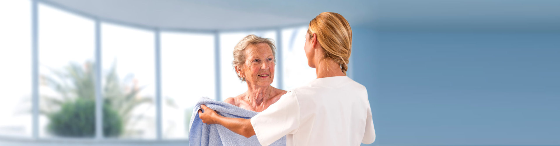 a caregiver assisting a senior woman in the shower